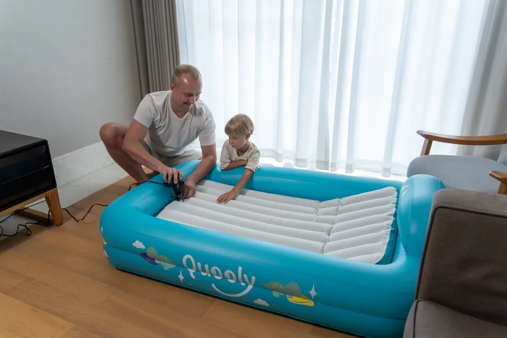 Dad and son setting up the Quooly bed together at home